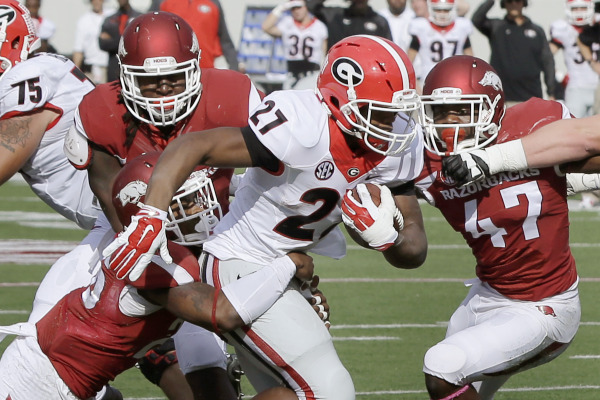 Georgia running back Nick Chubb (27) pushes past Arkansas defenders on Saturday (AP Photo/Danny Johnston on UGA website)